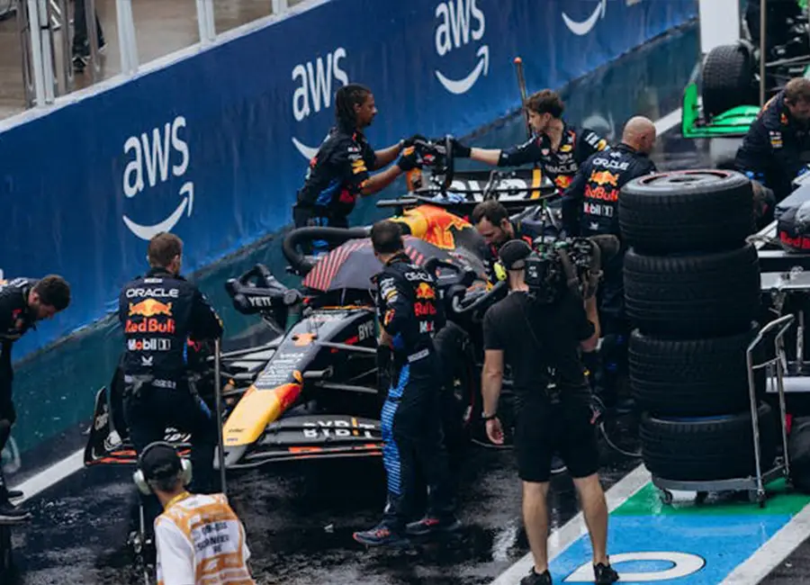 a man filming a pit stop